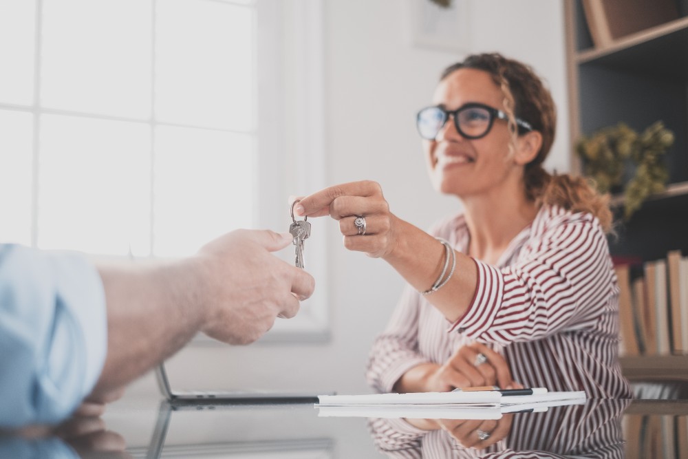 Woman getting the key after buying her first home